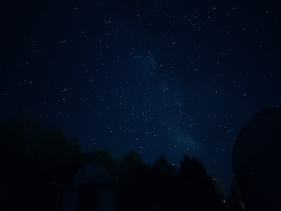 The image shows a view of the night sky, showing the milky way as seen from Alfred New York.